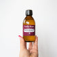 Hand holding a bottle of Earth House NZ Apricot Kernel Oil